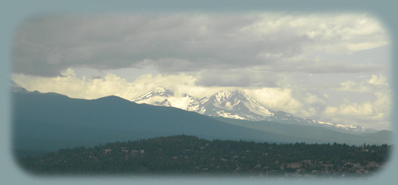 
hiking to the top of pilot butte in bend, in the high desert of central oregon, with views of the cascade mountains to the west: 3 sisters pictured here.