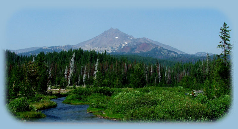 
hiking to the top of pilot butte in bend, in the high desert of central oregon, with views of the cascade mountains to the west: 3 sisters pictured here.