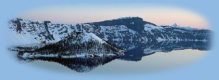 Winter in twilight at Crater Lake National Park in the cascade mountains of oregon - llao rock stands tall above the lake. hiking trails, national parks, national monuments, camping facilities, vacation spots in california and oregon in the cascade mountains, on the coast and more.
